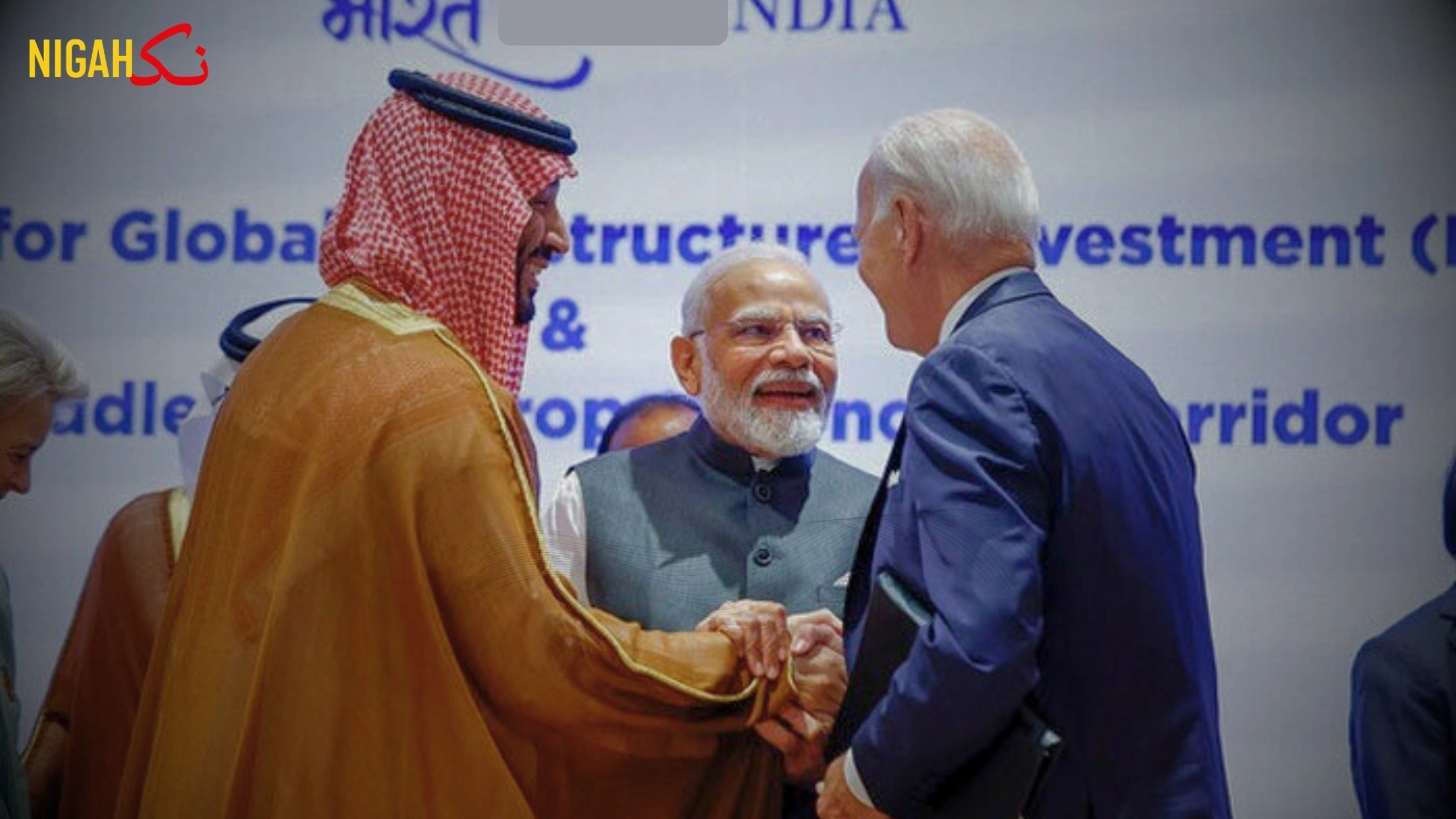 Indian Prime Minister Narendra Modi stands smiling between Saudi Crown Prince Mohammed bin Salman and U.S. President Joe Biden, who are shaking hands at a formal summit. Behind them, a backdrop reads 'भारत 2023 INDIA' and references the Partnership for Global Infrastructure Investment and the Middle East-Europe Economic Corridor, signaling international cooperation on strategic infrastructure.